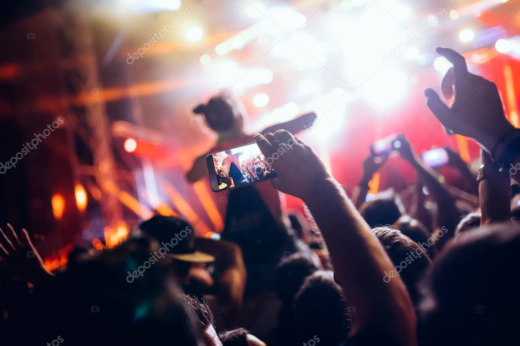 Portrait of happy dancing crowd enjoying at music festival