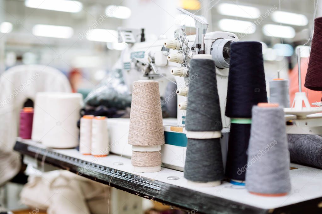 Wool and thread spools on desk used in textile industry