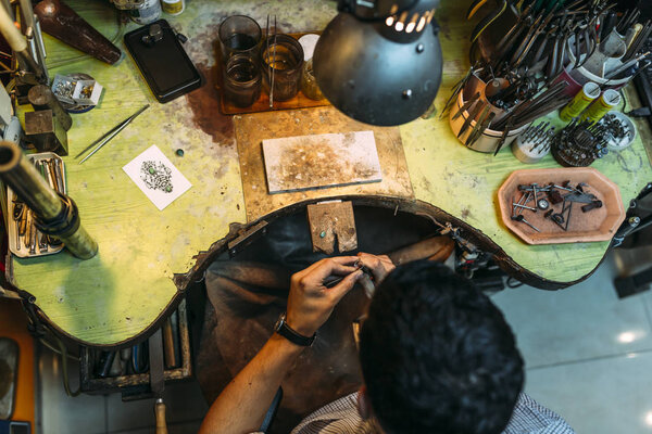 Worker working with his tools on a workbench