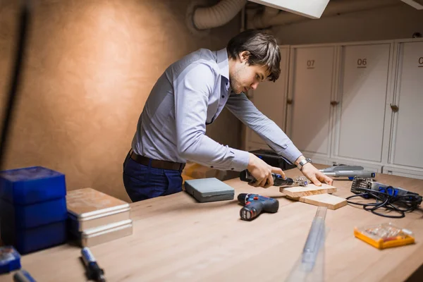 Handyman working with wood with precision tools at hand