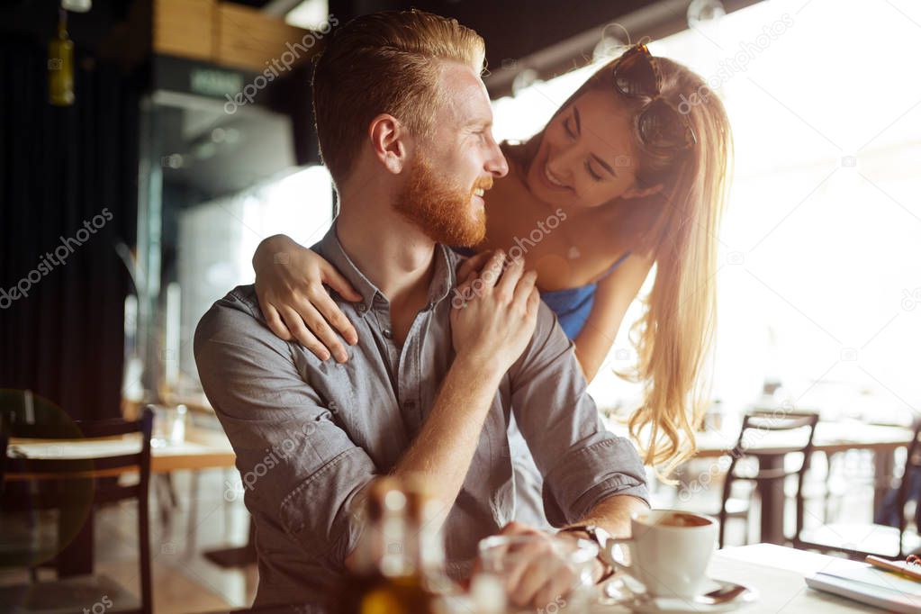 Beautiful man and woman flirt in cafe
