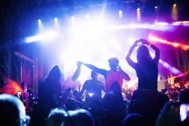 Portrait of happy dancing crowd enjoying at music festival clipart