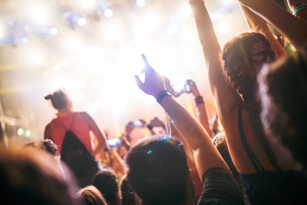 Portrait of happy dancing crowd enjoying at music festival