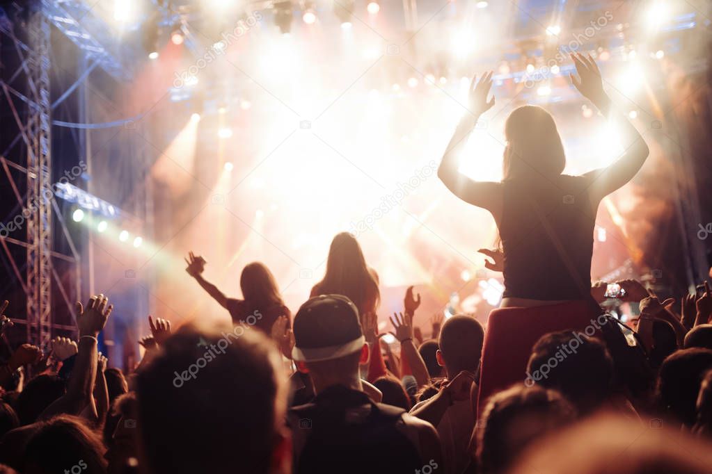 Portrait of happy dancing crowd enjoying at music festival