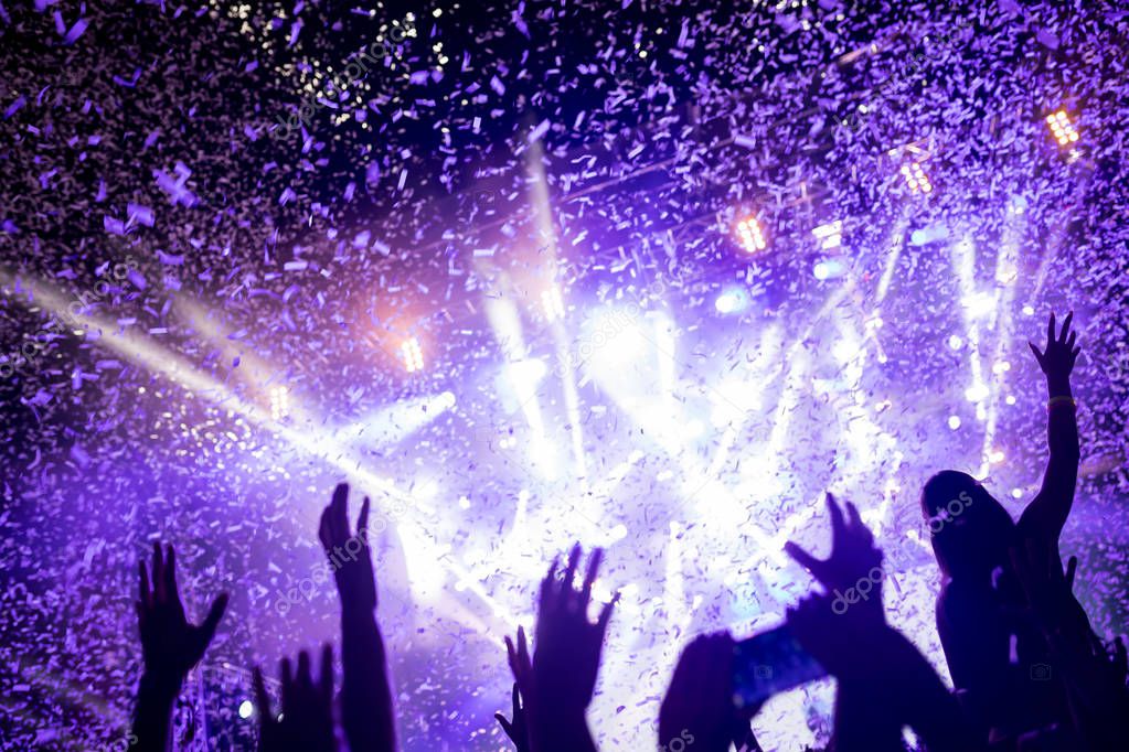 Portrait of happy dancing crowd enjoying at music festival