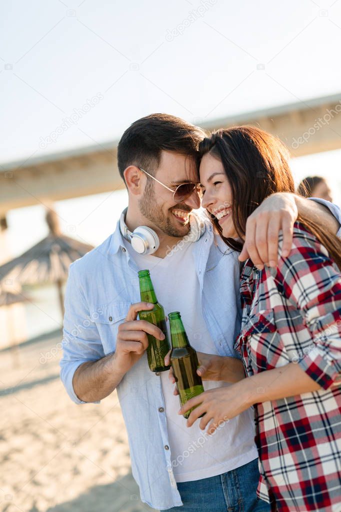 Truly happy playful couple in love having fun at beach