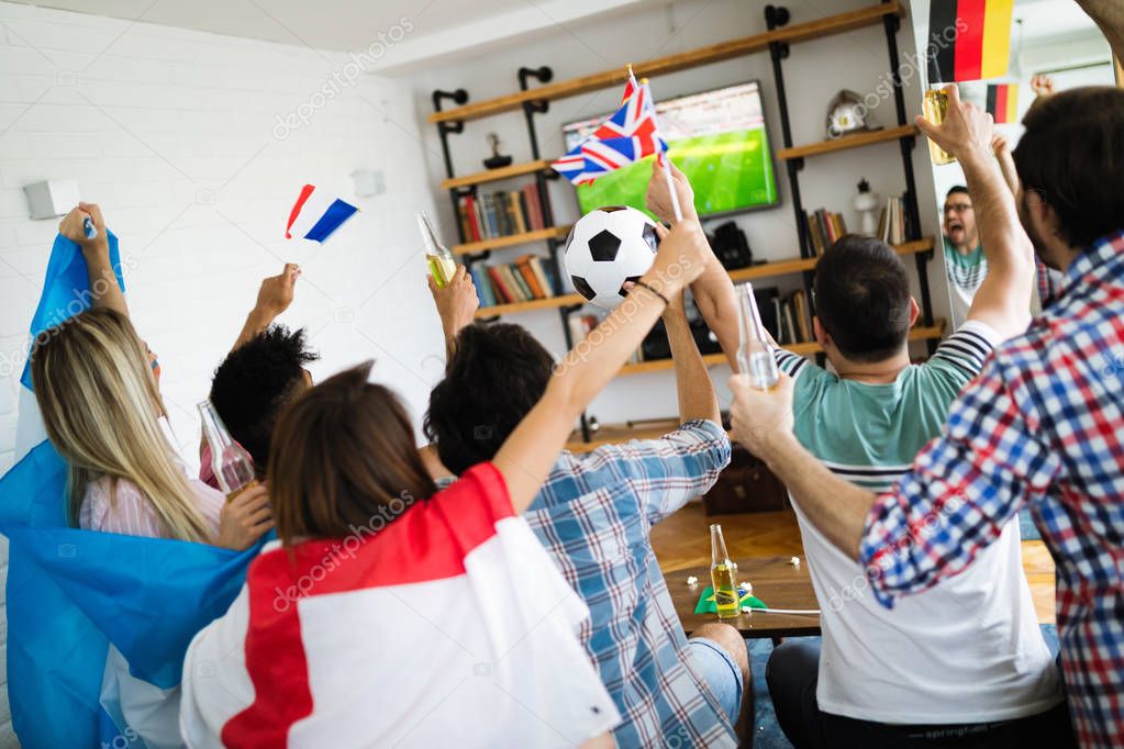 Group of multi-ethnic people celebrating football game and having fun