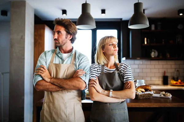 Unhappy married couple having argument and fight in kitchen that leads to divorce