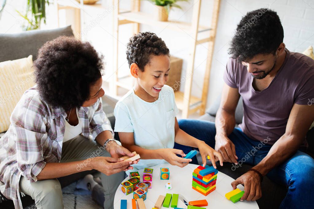 Family time. Young african american parents with two kids playing together at home