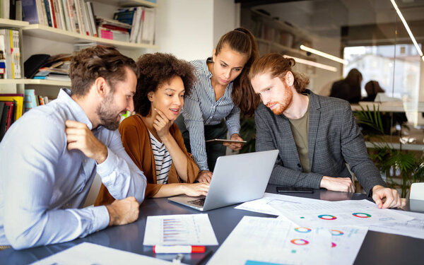 Group of business people architects collaborating on project in office