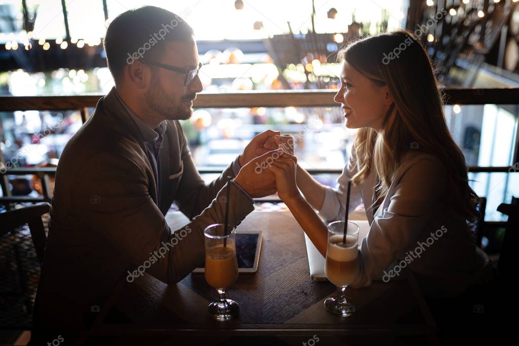 Attractive elegant young couple dating at the restaurant.