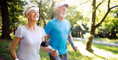 Aktif yaşlı çift sağlıklı yaşam için parkta çalışan