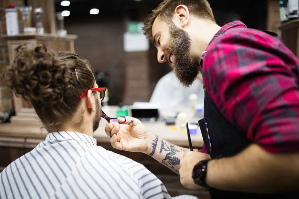 Man client during beard and moustache grooming in barber shop