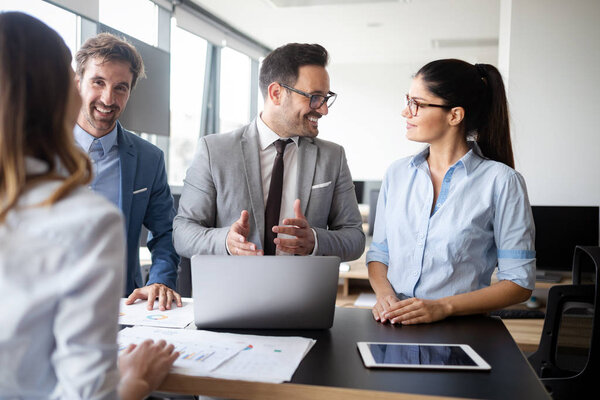 Group of successful happy business people at work in office