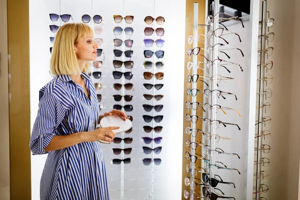 Beautiful Young Woman Choosing Glasses Optician Store — Stock Photo, Image
