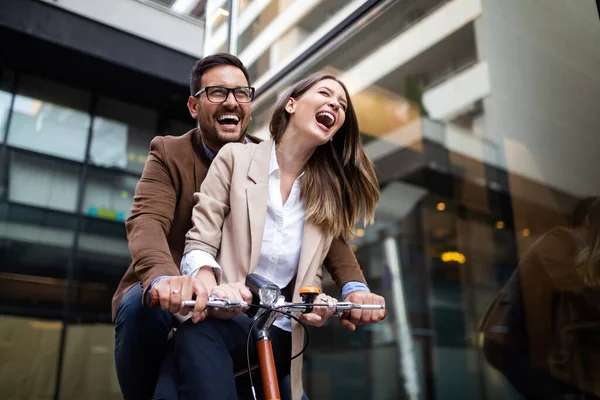 Happy young business managers couple embracing at street