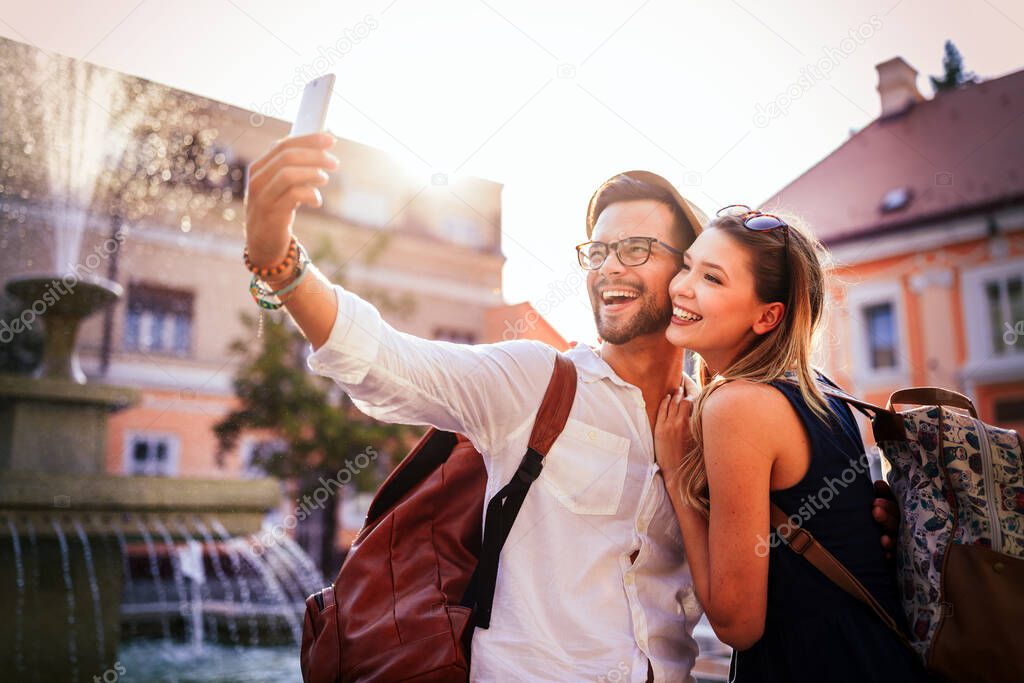 Summer holidays, dating, love and tourism concept. Smiling happy couple in the city