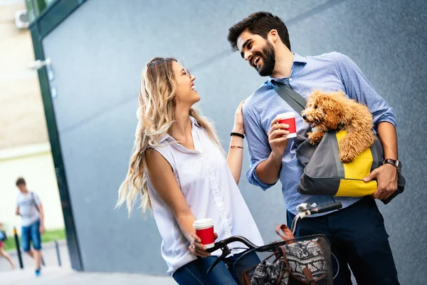 小さな犬の散歩で若いカップルを笑って 街で話して — ストック写真