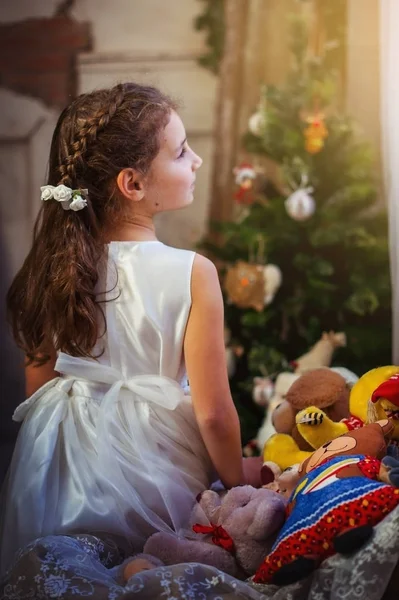 Child girl in a Christmas interior. — Stock Photo, Image