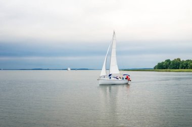 Bulutlu havalarda nehrinde yelken yat.