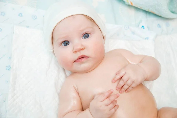 Naked Baby White Cap Lies Bed — Stock Photo, Image