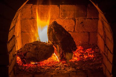 Bir şömine bulunan bir ateş yakar