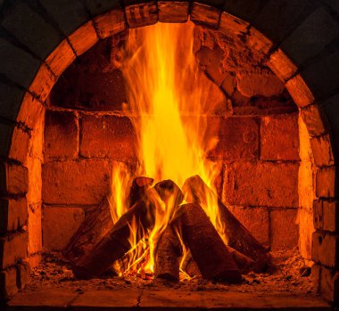 Bir şömine bulunan bir ateş yakar