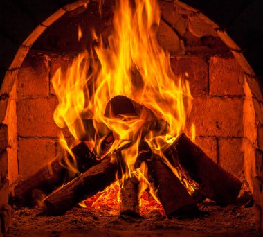 Bir şömine bulunan bir ateş yakar