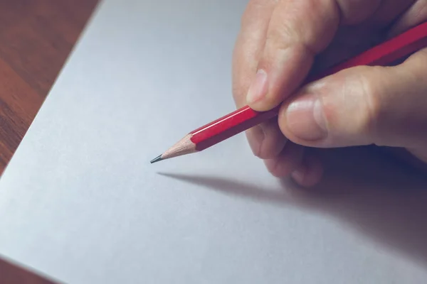 Uma foto próxima de uma pessoa escrevendo uma carta com um lápis — Fotografia de Stock