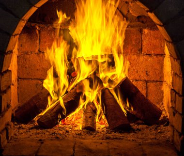 Bir şömine bulunan bir ateş yakar