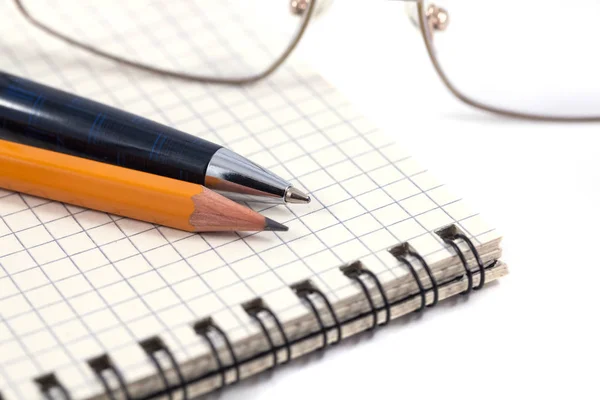 Eye glasses with pen, pencil and binder notebook Royalty Free Stock Photos