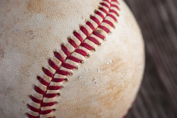 A baseball on an old wood table, sport — Stock Photo, Image