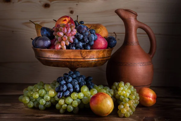 Autumnal fruit still life with Georgian jug on rustic wooden tab — Stock Photo, Image