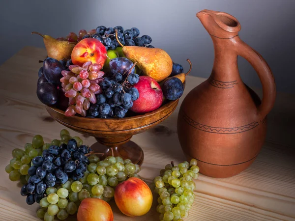 autumnal fruit still life with Georgian jug on rustic wooden tab