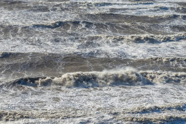 Stormy sea huge waves breaking near the coast