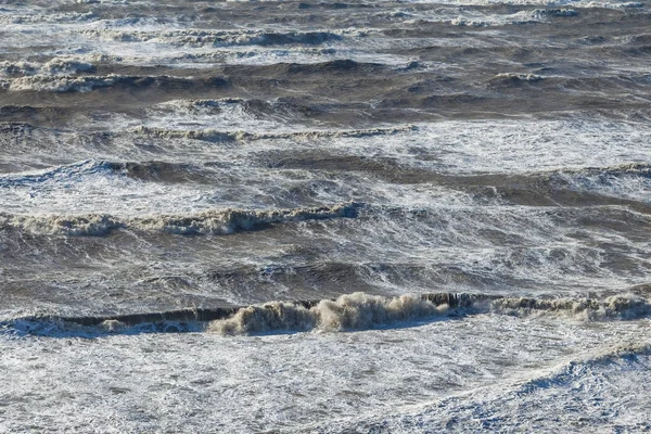 Stormy sea huge waves breaking near the coast