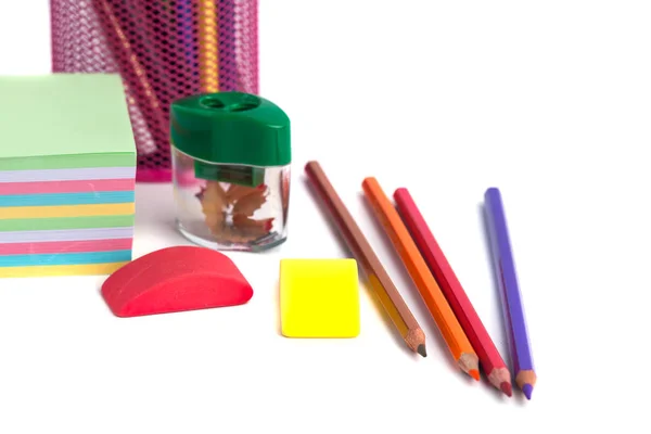 Colored pencils in the basket, Eraser and pencil sharpener on wh — Stock Photo, Image