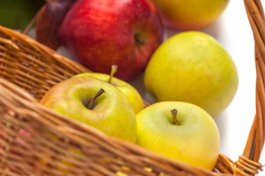 beyaz zemin üzerinde bir sepet elma.