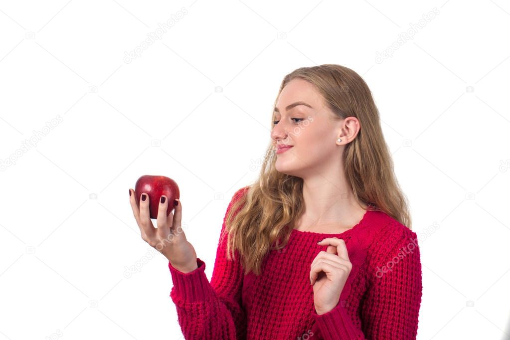 Pretty blonde girl with red apple in her hand, white background