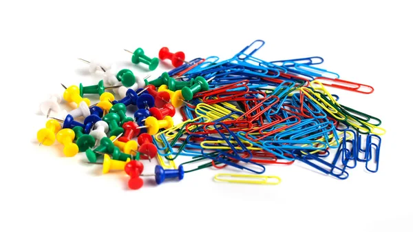 Bunch of colorful paper clips and tacks isolated on white backgr Stock Photo