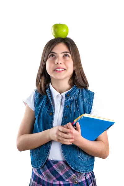 Söt skolflicka i uniform på vit bakgrund med apple på henne — Stockfoto