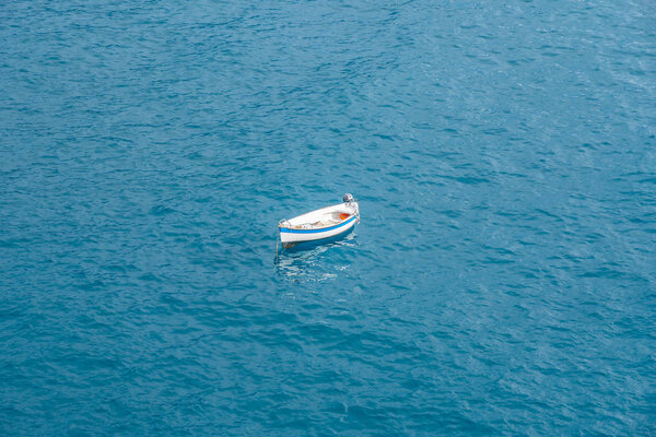 Small white boat in open sea.