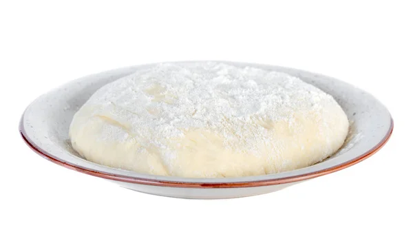 Сире тісто лежить на тарілці на білому тлі . — стокове фото
