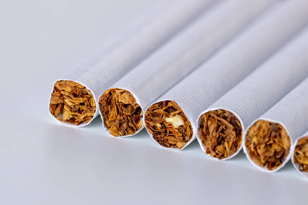 Closeup of a pile of cigarettes over white background