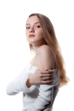 Portrait of beautiful female model looking over a shoulder on wh