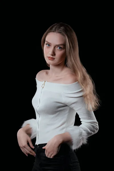 Blonde model with blue eyes over black background — ストック写真