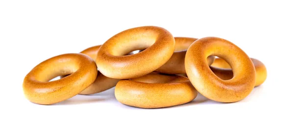 Små torra bagels, små rullar på en vit bakgrund — Stockfoto