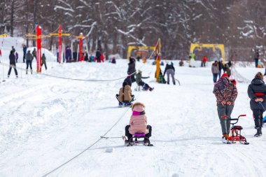 Skiers skiing climb a yoke on a mountain. Light skiing track in Bakuriani