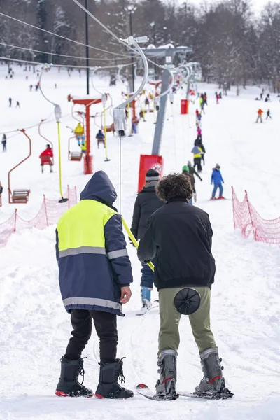 Skiers skiing climb a yoke on a mountain. Light skiing track in Bakuriani — стокове фото