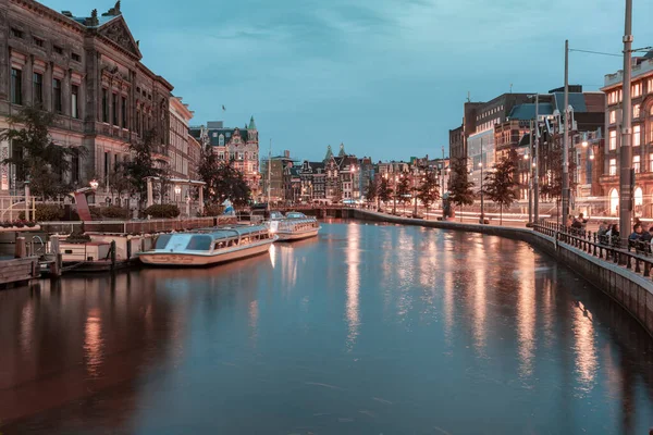 Amsterdam, Netherlands - October 14, 2019: Famous landscape in Amsterdam with unique building at night